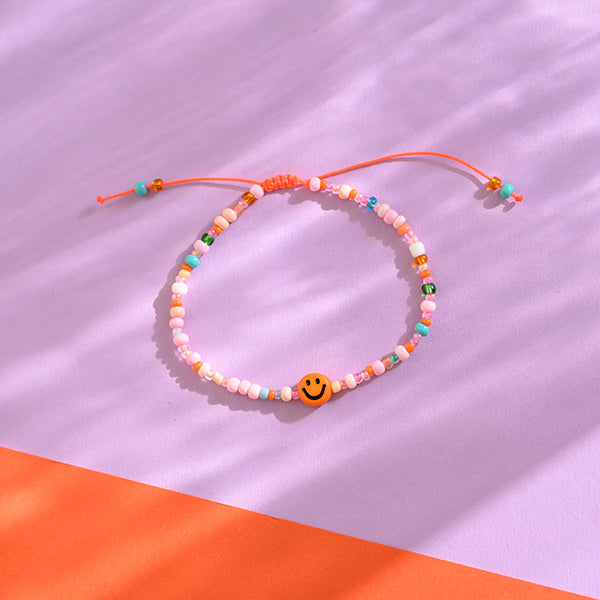 Perlenarmband orange/rosa smile mit Makrameeverschluss und Säckchen