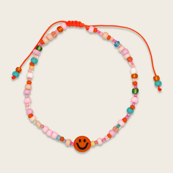 Perlenarmband orange/rosa smile mit Makrameeverschluss und Säckchen